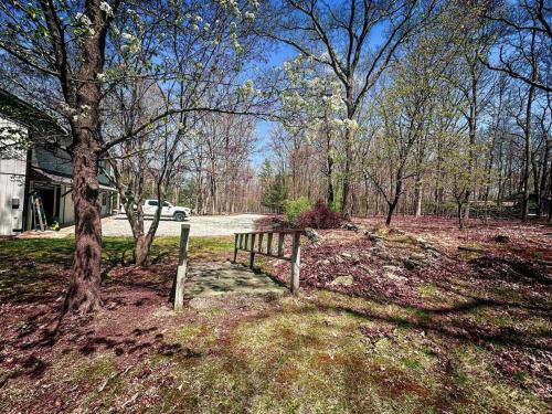 a fence in the middle of a field with trees at Pocono Mountains Luxury Retreat with king bed & game room in Cresco