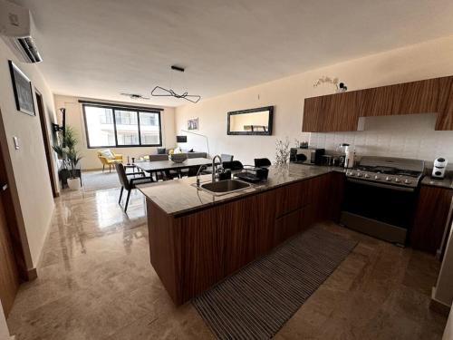 a kitchen with a counter top and a dining room at Depa Luxe 2HAB con Alberca y Playa Caminando in Boca del Río