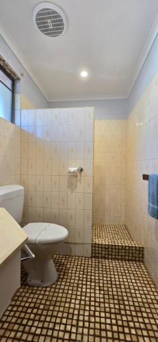 a bathroom with a toilet and a sink at Albatross Motor Inn in Lakes Entrance