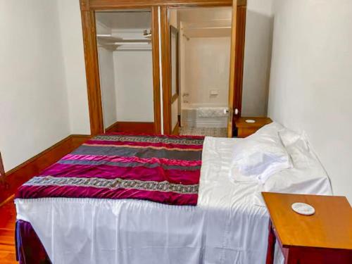 a bedroom with a bed with a blanket on it at Downtown Historic Victorian Charmer Sleeps 7 in Gainesville