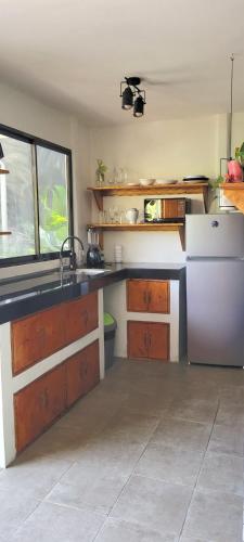 a kitchen with a sink and a refrigerator at Mecca in Puerto Viejo