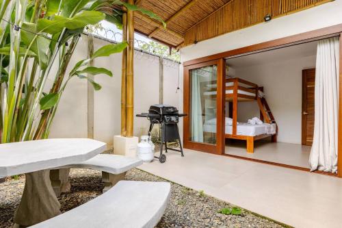an outdoor patio with a bed and a table at Villa Fruta del Cielo in Uvita