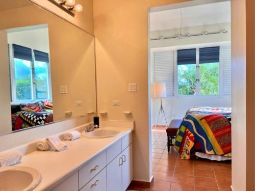a bathroom with two sinks and a bed at Villa Mango in North Coast in Dorado