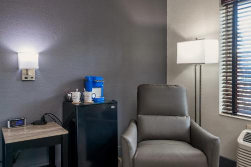 a waiting room with a chair and a table at Wood River Inn & Suite in Hailey