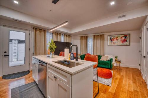 a kitchen with a sink and a living room at Modern & Colorful ~ 5* Location in Washington, D.C.