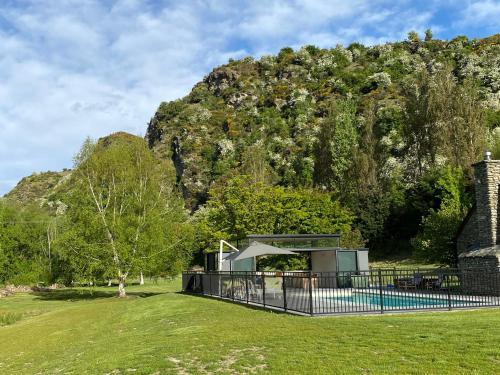 a picnic shelter in front of a mountain at Wharenui Holiday Home by MajorDomo in Arrowtown