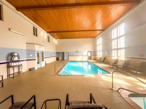 a swimming pool in a building with a wooden ceiling at Country Trails Inn &Suites in Lanesboro