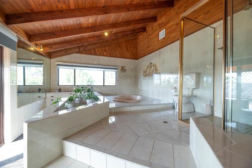 a large bathroom with a shower and a toilet at The Grand on Macquarie in Dubbo