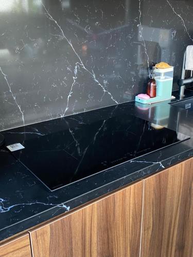 a black marble counter top in a kitchen at Villa AZJA PD in Port Dickson