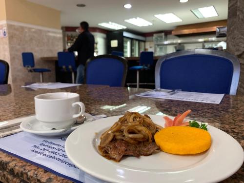 a plate of food on a table with a cup of coffee at Eurohotel in Panama City