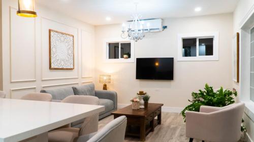 a living room with a table and chairs and a tv at Casa Sol in Trujillo