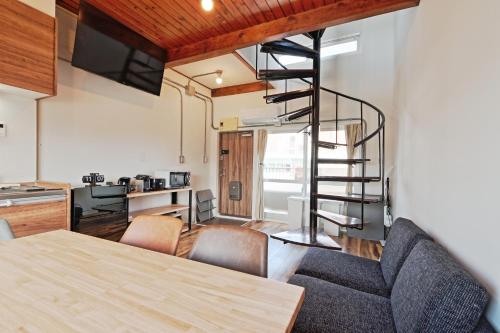 a kitchen and a living room with a spiral staircase at V Close to Olympic Stadium Sendagaya Roof top Terrace in Tokyo