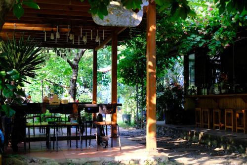 a pavilion with tables and chairs in a park at Blue Lagoon Cat Ba in Cat Ba
