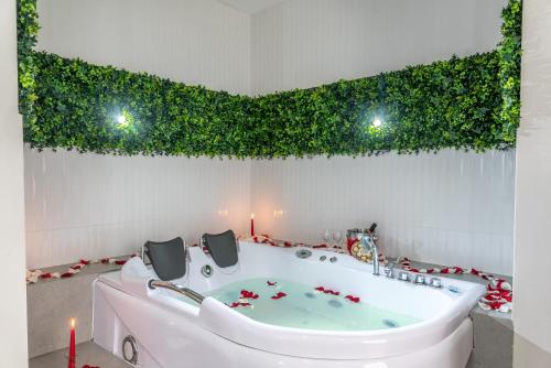 a bathroom with a bath tub with ivy on the wall at Hostería Paradero Yunguilla in Santa Isabel