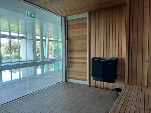a door to a building with a tv on the wall at Pullman Magenta Shores Resort in The Entrance