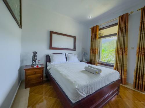 Ένα ή περισσότερα κρεβάτια σε δωμάτιο στο Mulia Garden Bungalows - Monthly Rate Available