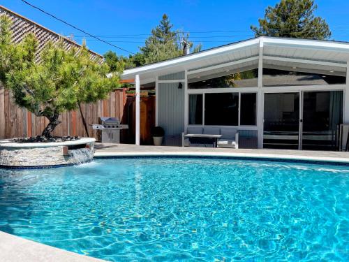 a swimming pool in front of a house at Redwood Oasis, Grove and Nook in Felton