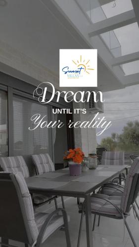 a table with chairs and a sign that reads dream within its own reality at Villa Sunset Yerakini in Poligiros