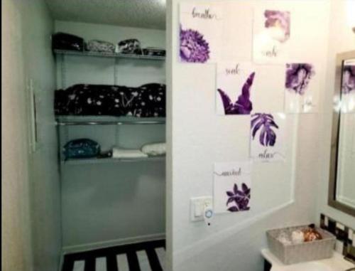 a bathroom with purple stickers on the wall at Unlv Cox studio in Las Vegas