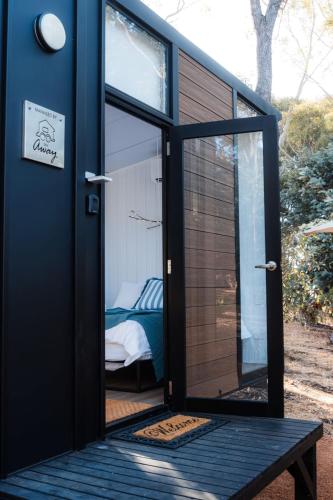 a door to a tiny house with a bedroom at Djindarup Retreat 2 by Tiny Away in Margaret River Town