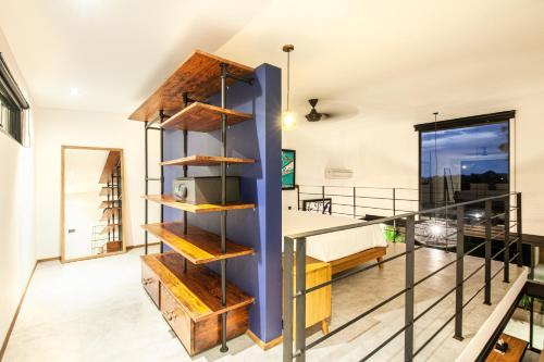 a room with a balcony with wooden shelves at New Duplex Apartment 200m To Beach Canggu in Canggu