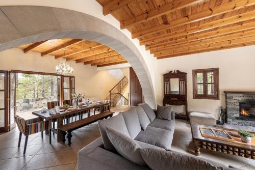 a living room with a couch and a table at Troodos Mature Pine Chalet in Pedoulas