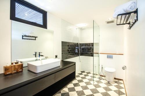 a bathroom with a sink and a shower at New Duplex Apartment 200m To Beach Canggu in Canggu
