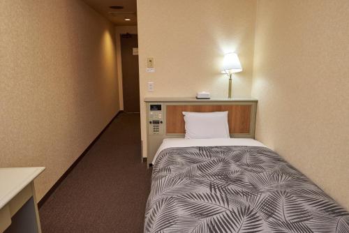 Una cama o camas en una habitación de Hotel Machida Villa