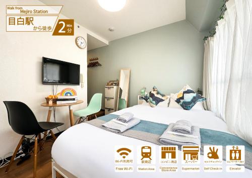 a bedroom with a bed and a desk and a tv at nestay apartment tokyo ikebukuro in Tokyo