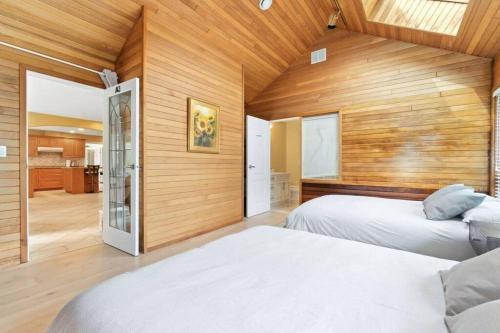 2 camas en una habitación con paredes de madera en Cozy Retreat in Richmond en Richmond