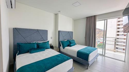 Una cama o camas en una habitación de Hotel Marco Polo Rodadero
