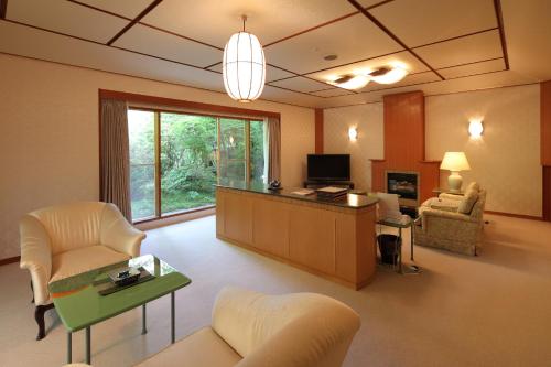 a large living room with a couch and a table at Hanzuiryo in Unzen