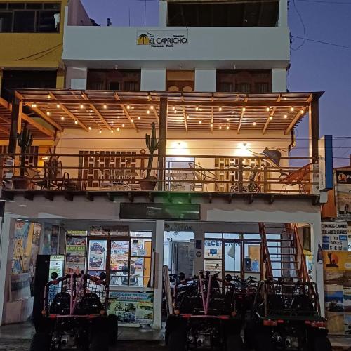 a building with a balcony on top of it at El Capricho Paracas in Paracas