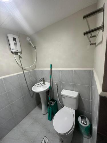 a bathroom with a toilet and a sink at Lapu-Lapu City Condo in Lapu Lapu City
