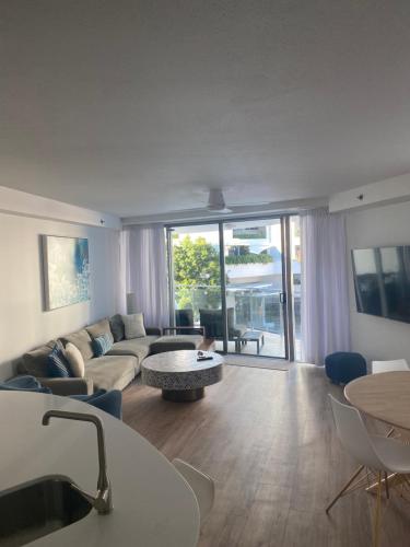 a living room with a couch and a table at Cilento Mooloolaba in Mooloolaba