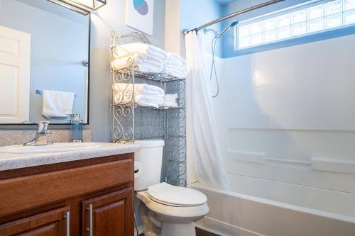 a bathroom with a toilet and a sink and a shower at Downtown home with view of Tower of the Americas in San Antonio