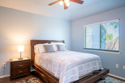 a bedroom with a bed with a ceiling fan and a window at Downtown home with view of Tower of the Americas in San Antonio
