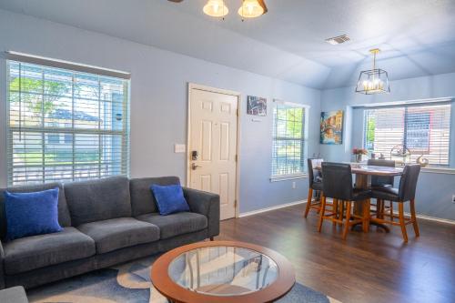 a living room with a couch and a table at Downtown home with view of Tower of the Americas in San Antonio