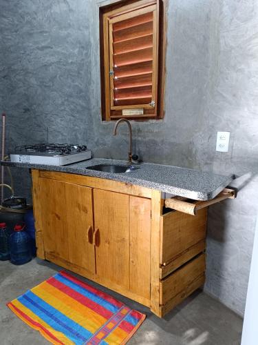 a kitchen with a sink and a counter top at Chalé Rj Rio in Santo Amaro
