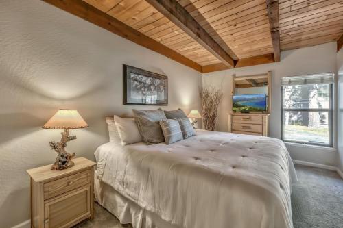 a bedroom with a large bed and a window at Lakeland Village 410 in South Lake Tahoe