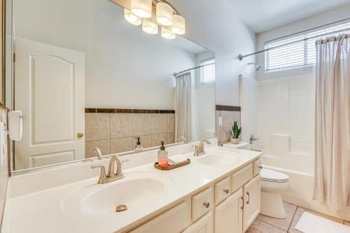 a bathroom with a sink and a toilet and a mirror at Coldwater Golf Course Getaway in Avondale! in Avondale