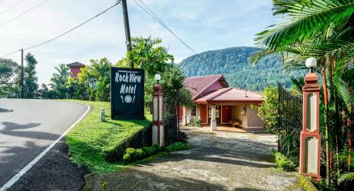 a sign for a hotel on the side of a road at Rock View Sinharaja in Kalawana