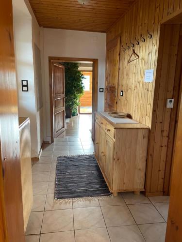 a kitchen with wooden walls and a tile floor at Uriges Bauernhaus mit Blick auf Graz in Graz