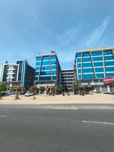 a building with blue windows on the side of a street at HOTEL NEW YORK in Ahmedabad