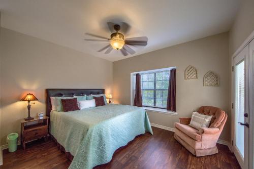 a bedroom with a bed and a ceiling fan at SS 6B Teckelhaus in New Braunfels