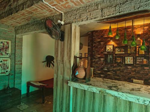 a living room with a brick wall and a window at Shobhayan inn, airport railway station pickup free in Ayodhya