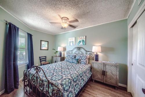 a bedroom with a bed and a ceiling fan at Riverpalooza RRC A305 in New Braunfels