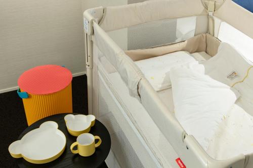 a hospital crib with a table next to it at HOTEL MASTAY jingumichi in Kyoto