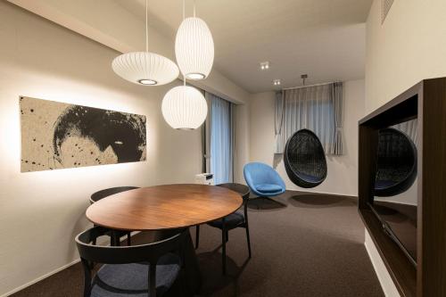 a dining room with a table and chairs at HOTEL MASTAY jingumichi in Kyoto