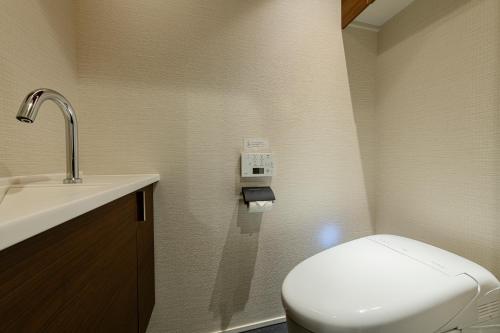 a small bathroom with a toilet and a sink at HOTEL MASTAY jingumichi in Kyoto
